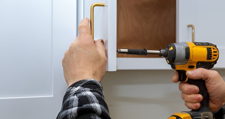 close-up of a man installing a kitchen cabinet handle