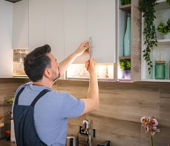 man installing a kitchen cabinet handle