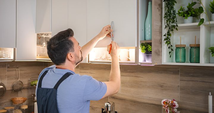 man installing a kitchen cabinet handle